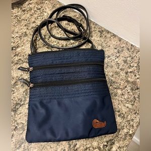 Dooney & Bourke nylon dark blue crossbody with 3 zippered compartments.
